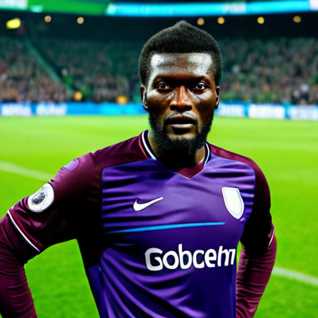 A professional male soccer player, resembling Emmanuel Adebayor, standing strong and determined on a vibrant green soccer pitch inside a grand stadium. He is fully clothed in a professional, modest, and appropriate soccer kit, radiating focus and power. The background features blurred stadium lights and a cheering crowd, emphasizing a professional match atmosphere. Perfect anatomy, correct proportions, natural pose, well-formed hands, proper finger count, natural body proportions, professional sports photography, high quality, sharp focus, safe for work, appropriate content, fully clothed, professional dress.